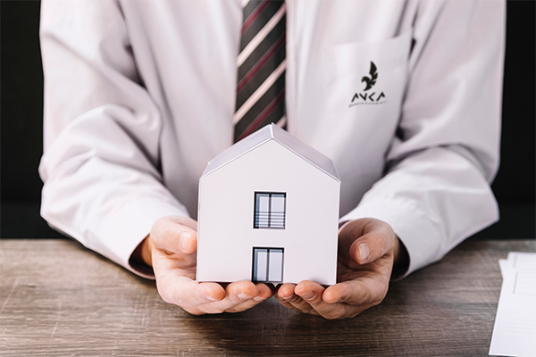 crop-man-holding-paper-house-2